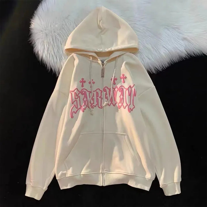 A cream-colored Maramalive™ Goth Embroidery Hoodies Women High Street Retro Hip Hop Zip Up Hoodie Loose Man Sweatshirt Hoodie Clothes Y2K Hoodie with a front zipper features the word "sabbath" in pink gothic letters and small cross graphics. The streetwear hoodie is laid on a black surface with a white fur background.