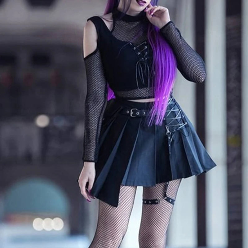 Person with long purple hair wearing a Maramalive™ Goth Dark Techwear Fishnet Open Shoulder Halter T-shirts Mall Gothic Grunge Black Bandage Crop Tops Women Punk Sexy Alt Clothing, pleated skirt with laced details, fishnet stockings, and a garter—a perfect blend of grunge goth punk aesthetics.