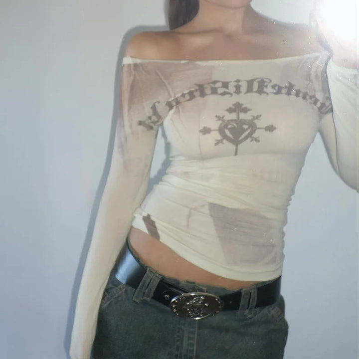 A person is wearing the Maramalive™ Cryptographic Letter Print Long Sleeve Off Shoulder Slim Tops See Through Sexy Graphic T-Shirts Tee Women Goth Aesthetic Clothes, paired with a black belt and high-stretch gray pants—perfect for a sexy & club look.