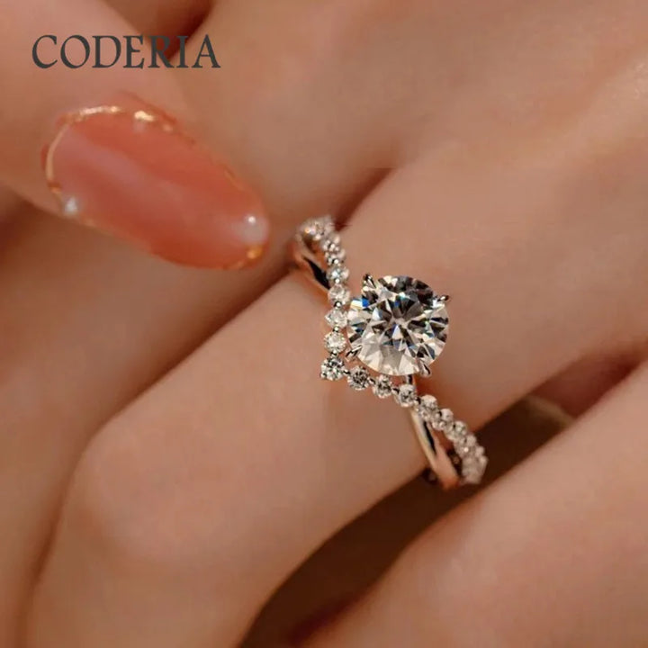 A hand with a manicured fingernail displays a stunning engagement ring, featuring the Maramalive™ Pass Diamond Test D Color 1 Carat Moissanite Wedding Ring High Quality 18K White Gold Rings Fashion Sterling Silver Jewelry.