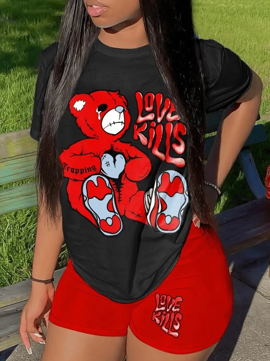 A person wearing a Maramalive™ LW Plus Size Summer Casual 2 Piece Set Letter Print Shorts Set 2 Piece Outfit O Necke Short Sleeve T Shirt Top with short pants featuring a graphic of a distressed red teddy bear and the text "Love Kills." They are also sporting matching red shorts from Maramalive™ with the same text, showcasing their casual style. The background shows a green grassy area perfect for outdoor activities.