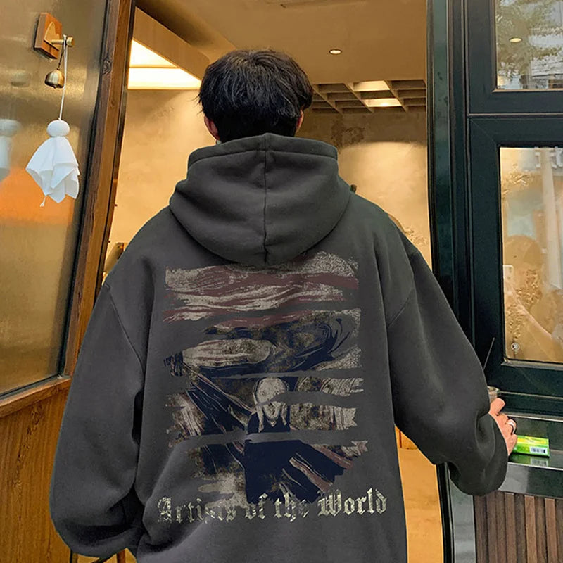 A person wearing a dark Maramalive™ Autumn Goth Graphic Print Hooded Sweatshirts For Men Oversized Y2K Streetwear Hoodies New In Fashion Pullover Hoodie with a graphic design and the text "Union of the World" on the back, standing at the entrance of a building.