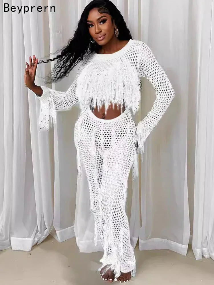 "Model in sparkly, sequined tassel white jumpsuit."