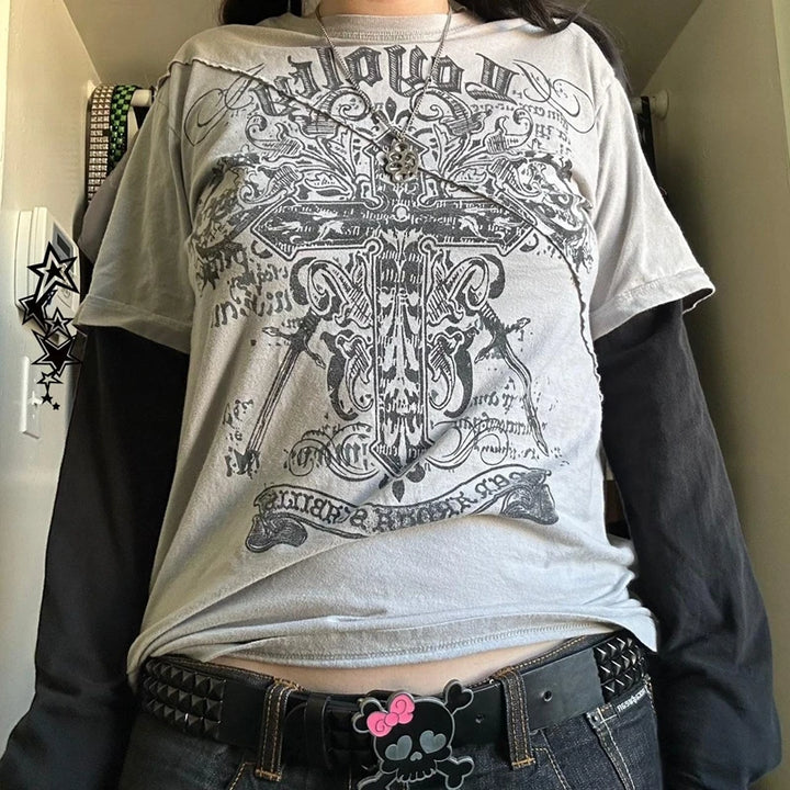 Person wearing a Maramalive™ 2000s Retro Mall Goth Graphic Print Loose Tops Cyber Y2K Grunge Vintage Oversize T-shirt Fake 2 Pice Patchwork Long Sleeve Tees, with a studded belt featuring a Hello Kitty buckle, standing in front of a white wall. The look embodies Y2K style perfectly.