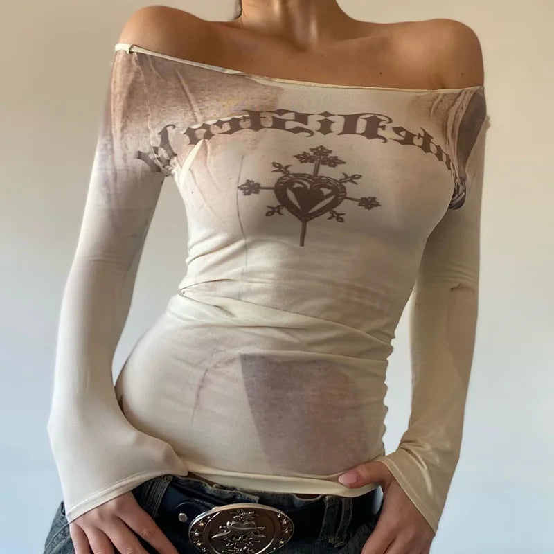 Person wearing a high-stretch, *Maramalive™ Cryptographic Letter Print Long Sleeve Off Shoulder Slim Tops See Through Sexy Graphic T-Shirts Tee Women Goth Aesthetic Clothes* with a heart design and lettering, paired with jeans and a belt.