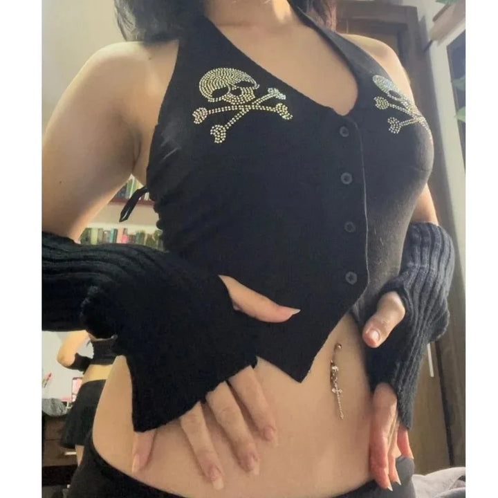 Person wearing a Maramalive™ Goth Dark Skull Rhinestone Mall Gothic Halter Tops Grunge Aesthetic Button Up Emo Crop Top Punk Sexy Backless Bandage Alt Outfit, fingerless gloves, and a belly button piercing with a keychain pendant.