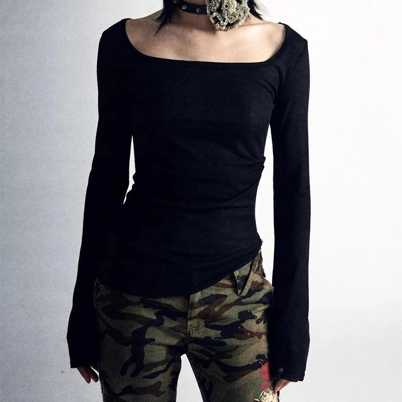 Person wearing a black, long-sleeved Maramalive™ 90s Vintage E-girl Emo Clothes Fires Graphic Print Y2K Grunge T-shirt Women Retro Long Sleeve Tee Goth Punk Streetwear and camouflage pants, complemented by a choker necklace. The upper face is not visible, adding an enigmatic twist to the vintage style look.
