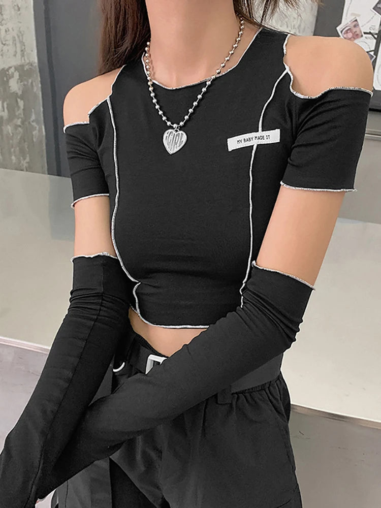A person is wearing a Maramalive™ Goth Dark E-girl Style Patchwork Black T-shirts Gothic Open Shoulder Sleeve Y2k Crop Tops Ruffles Hem Hip Hop Techwear Women Tee, long black sleeve extensions, and a necklace with a heart-shaped pendant, epitomizing gothic casual streetwear.