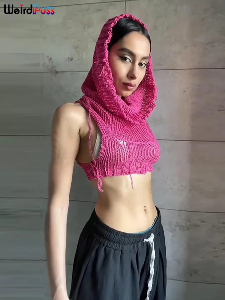 Person wearing a Maramalive™ Knit Hooded Tank Top Y2K Women Solid Crochet Sleeveless Sexy Navel Camisole Stretch Skinny Street Hipster Wild Vest, paired with black pants, standing against a tiled wall.
