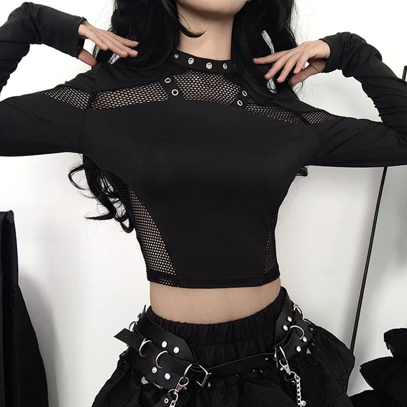 Person wearing a Maramalive™ Goth Dark Techwear Cyber Gothic Fishnet Patches T-shirt Punk Grunge Hollow Out Skinny Crop Top Black Eyelet Fashion Alt Clothe and a belted skirt with silver studs, embodying Gothic Streetwear. Their face is not visible.