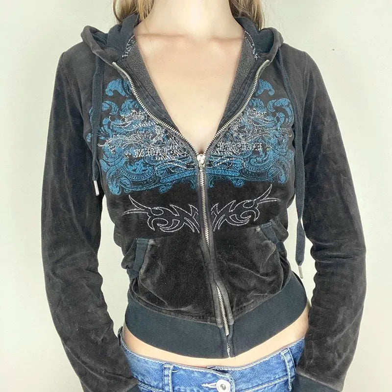 A person wearing a Maramalive™ Y2K Aesthetic Vintage Slim Sweatshirts Embroidery Graphic Pattern Zip Up Hoodies 2000s Retro Grunge Mall Goth Jacket Autumn Coat with intricate blue and gray embroidery designs over a pair of blue jeans.