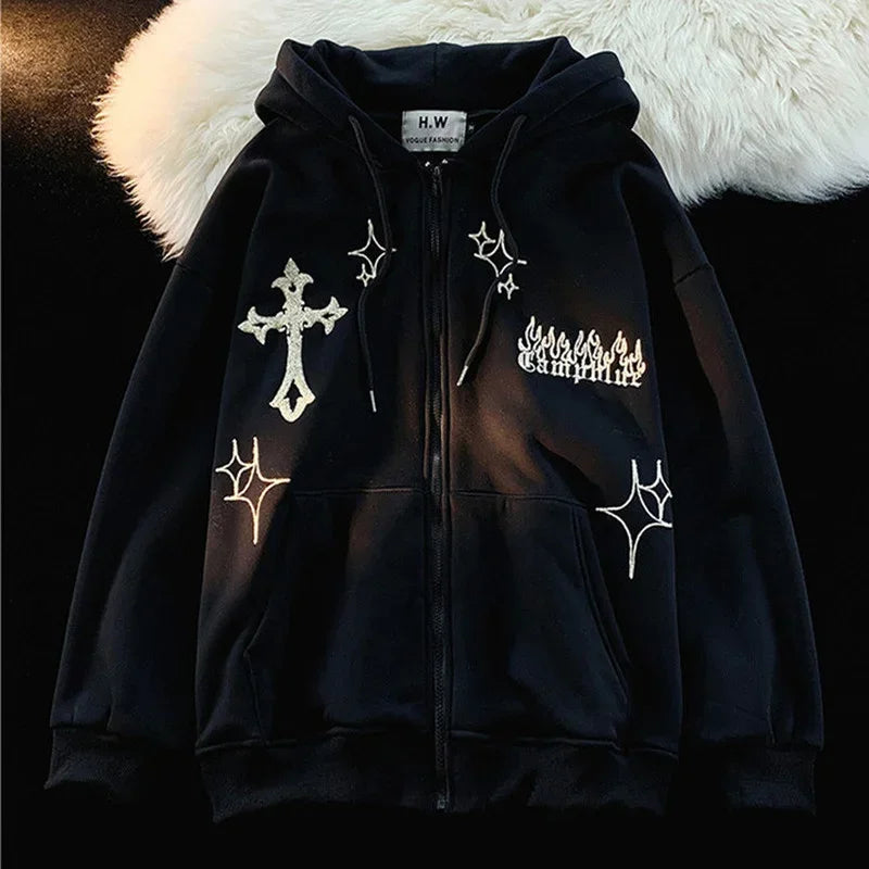A black hooded jacket featuring a cross, stars, and flame graphics, labeled "Embroidery Sweatshirt Women Oversized Zip-Up Hoodies Gothic Hip Hop Hooded Streetwear Female Hoodie Y2k Full Jacket" by Maramalive™. This Gothic Hip Hop Streetwear piece has a zip-up front and a white furry backdrop.