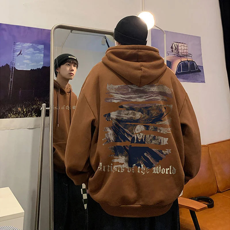 A person wearing a Maramalive™ Autumn Goth Graphic Print Hooded Sweatshirts For Men Oversized Y2K Streetwear Hoodies New In Fashion Pullover Hoodie stands in front of a mirror, facing away. The reflection shows their face. The room, decorated with Y2K clothing vibes, has posters on the walls and a couch visible.