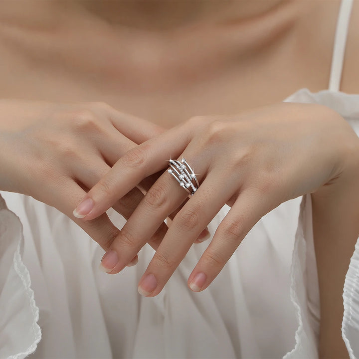 A person wearing a white sleeveless top with their hands crossed, displaying a stunning Szjinao Trendy Moissanite Ring Eternity Wedding Band Solid 925 Silver Rings For Women Jewelry Engagement Gift Dropship Supplier by Maramalive™ on their fingers.