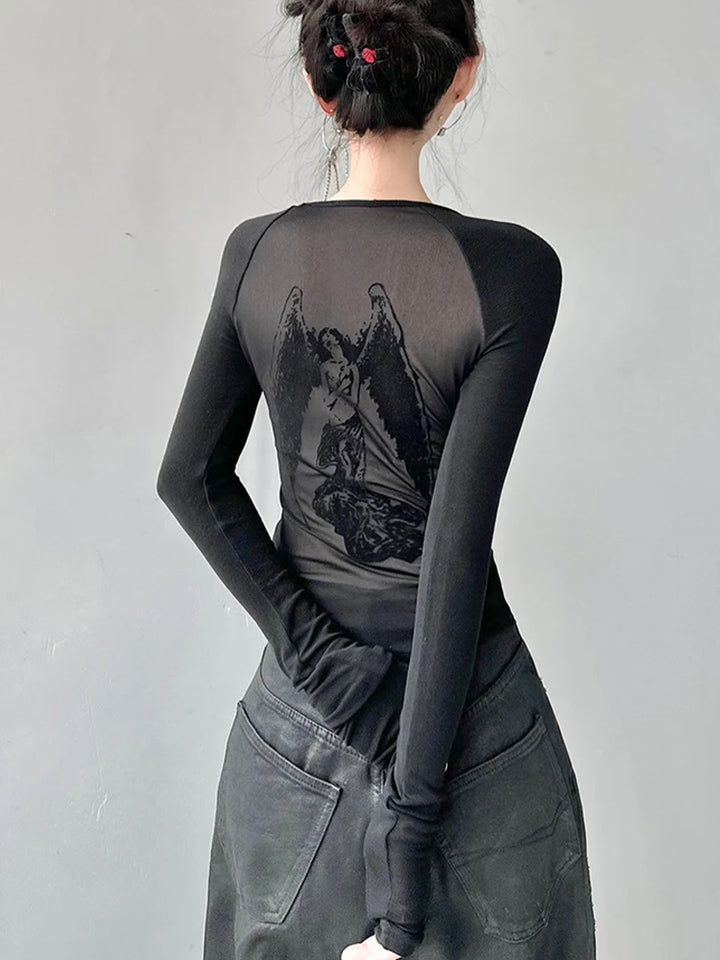 A person with their back turned is wearing the Maramalive™ Gothic See Through Angel Graphic Print T-shirt for Women Goth Punk Slim Fit Sexy Mesh Y2k Long Sleeve Grunge Transparent. Perfect for the Spring/Summer season, this sexy & club style has their hands behind their back and hair tied up.