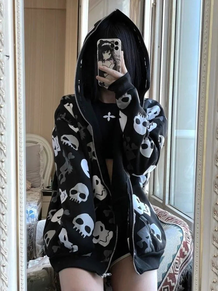 Person wearing a Maramalive™ Gothic Punk Skull Hoodies Women Mall Goth Tops Streetwear Black Long Sleeve Zip Up Hooded Sweatshirt 2022 Autumn taking a mirror selfie holding a phone with an anime character case, blending perfectly into the latest Autumn 2022 streetwear trends.