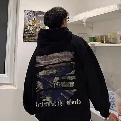 A person wearing a Maramalive™ Autumn Goth Graphic Print Hooded Sweatshirts For Men Oversized Y2K Streetwear Hoodies New In Fashion Pullover Hoodie stands in a room with white shelves filled with various items and a poster on the wall.