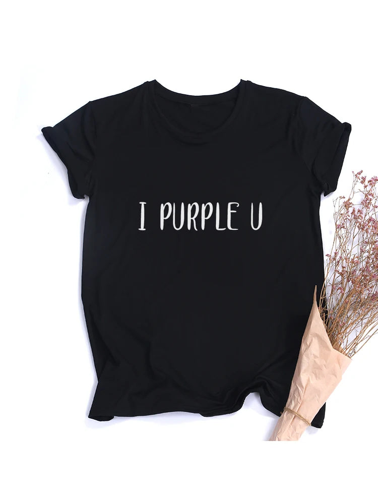 A black Casual Women's T-Shirt with the text "I PURPLE U" printed in white letters. A dried floral arrangement is placed on the right side of this Maramalive™ Female Short Sleeve KPOP I PURPLE U T-shirt Aesthetic High Quality Haut Femme Summer Top Tee Shirt Streetwear Cute Tshirts, perfect for Spring/Summer Tees.
