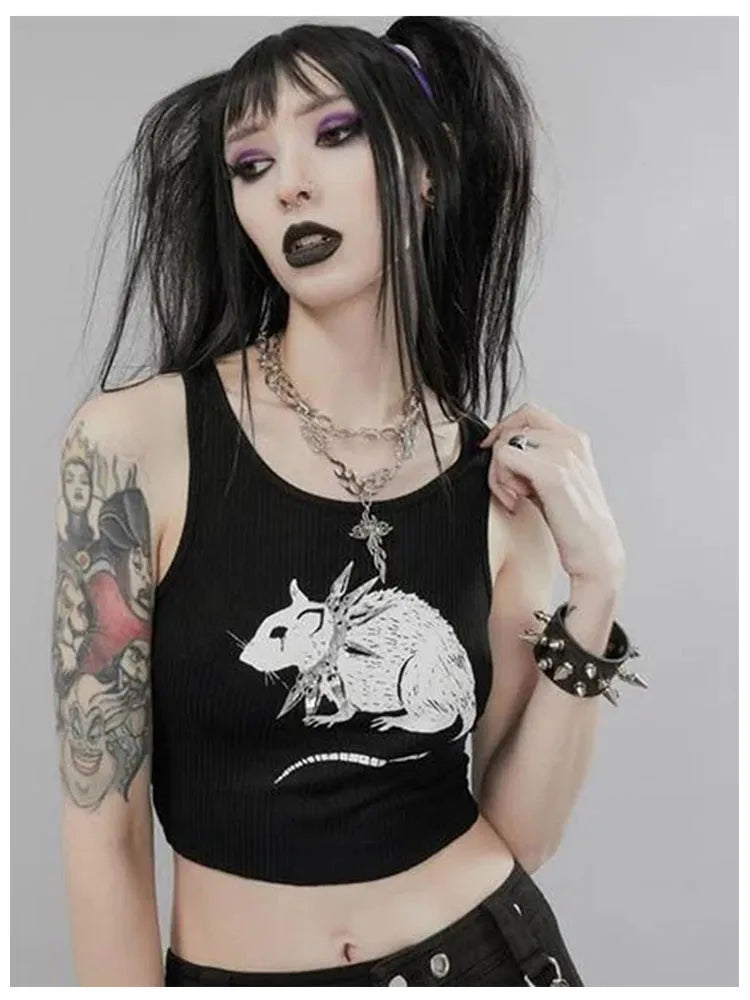 A person with black hair and makeup, adorned in a gothic ensemble featuring the Maramalive™ Mouse Print Black Tank Goth Sexy Bodycon Cropped Tops Women Streetwear O Neck Knitted Basic Tank Top, spiked bracelet, and necklaces, stands against a grey background.