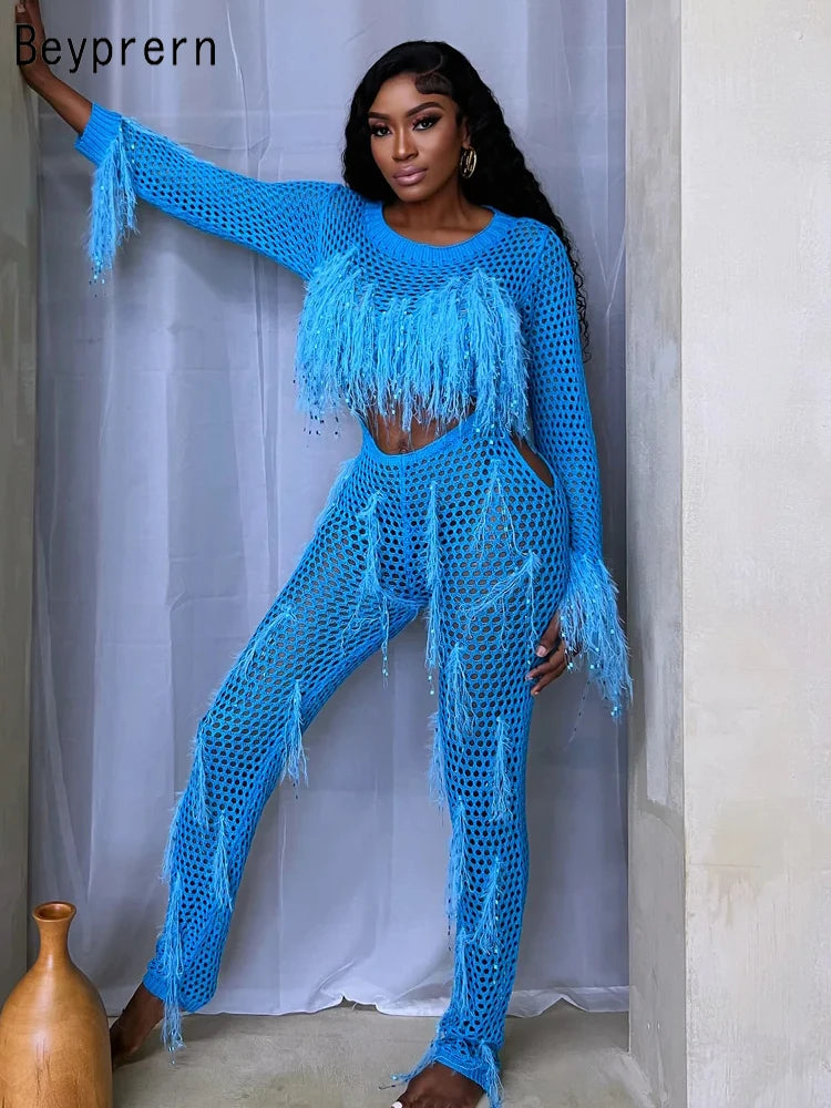 "Model in sparkly, sequined tassel blue jumpsuit."