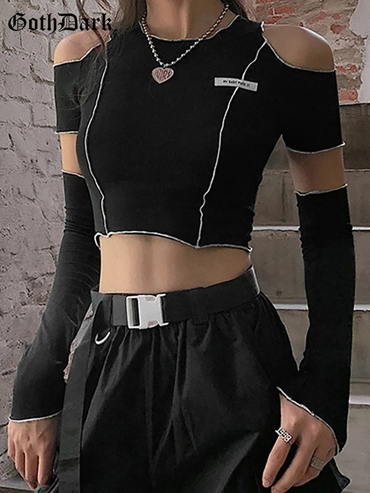 A person wears the Maramalive™ Goth Dark E-girl Style Patchwork Black T-shirts Gothic Open Shoulder Sleeve Y2k Crop Tops Ruffles Hem Hip Hop Techwear Women Tee with black high-waisted pants and a belt, embodying Gothic Casual Streetwear.