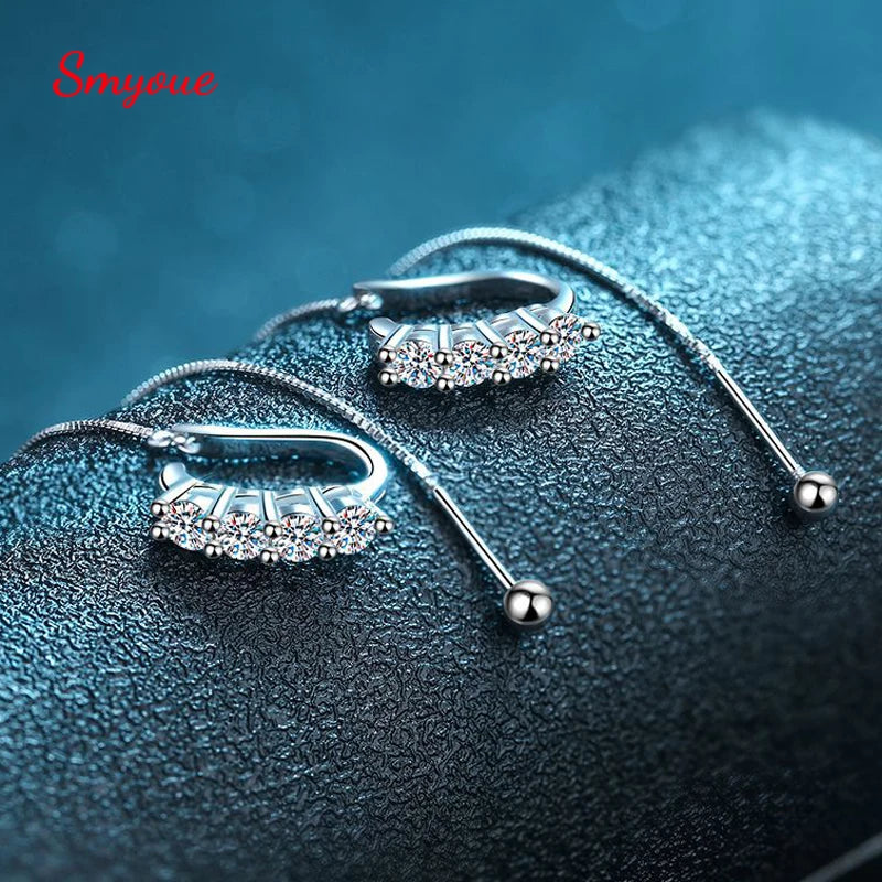 Luxury Moissanite Earrings sparkling on a lit white background. 
