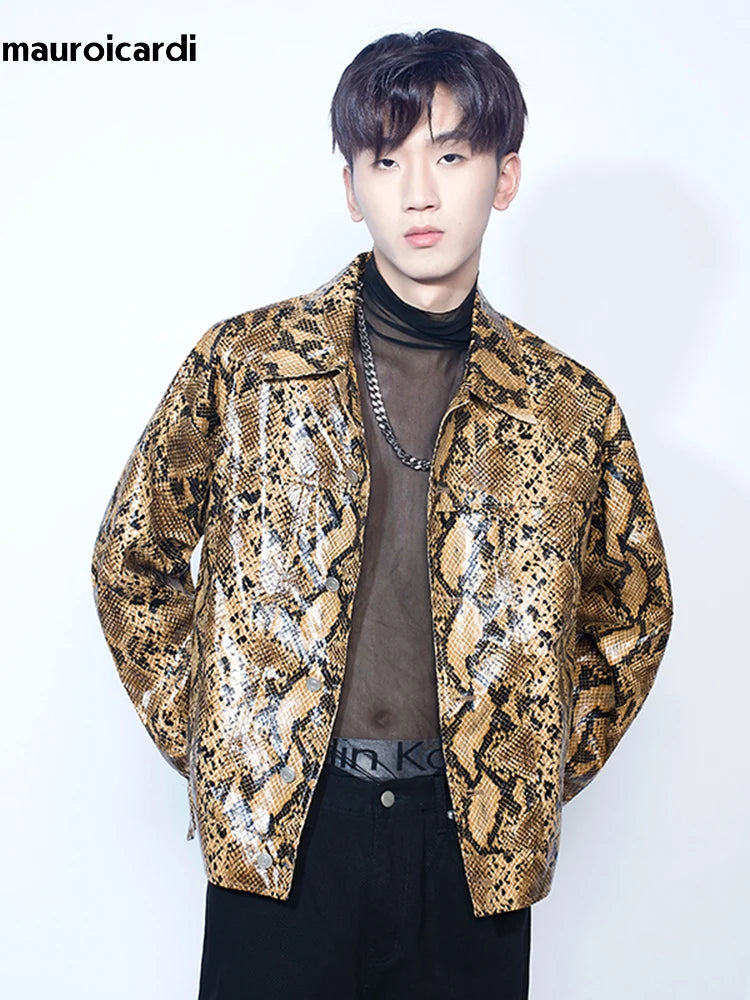 A man poses against a white background, showcasing youthful casual style with a Maramalive™ Loose Cool Shiny Colorful Snakeskin Print Pu Leather Jacket Men Luxury Designer Clothes Streetwear over a sheer black top and black pants, exemplifying cutting-edge men's outerwear.