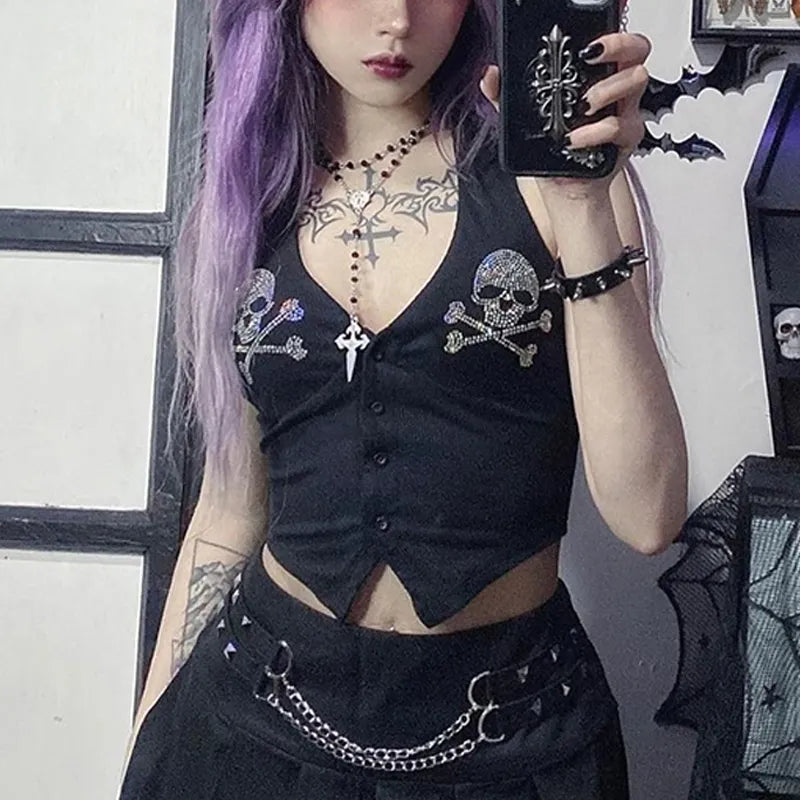 A person with long purple hair wearing a Maramalive™ Goth Dark Skull Rhinestone Mall Gothic Halter Tops Grunge Aesthetic Button Up Emo Crop Top Punk Sexy Backless Bandage Alt Outfit, holding a black phone with a cross ornament, and standing in a room with gothic decor.
