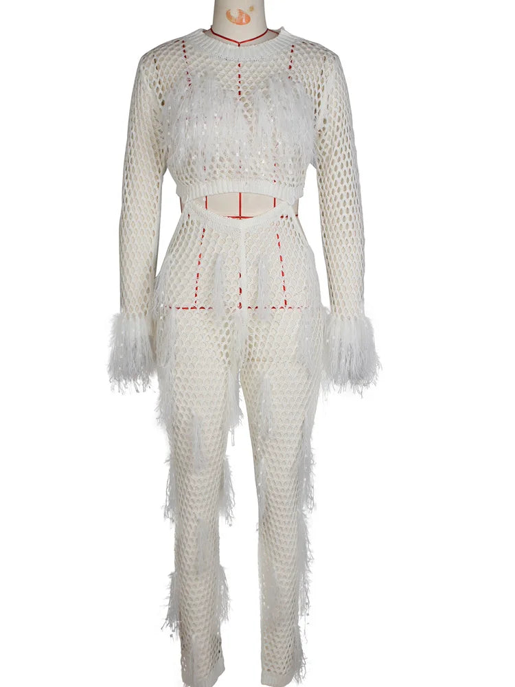 "Model in sparkly, sequined tassel white jumpsuit."