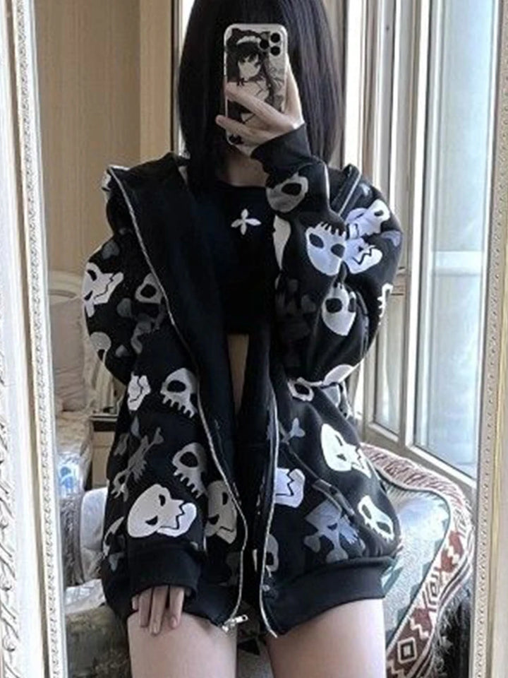 Person taking a mirror selfie wearing a Maramalive™ Cyberpunk Y2k Sweatshirt Women Mall Goth Skull Printed Long Sleeve Zipper Cardigan Hoodie Emo Alt Indie Clothes, a cropped black top, and black shorts. Their phone has a character print on the case.