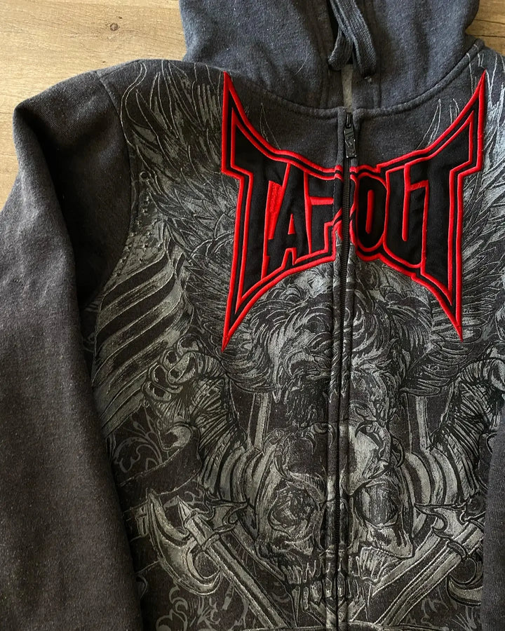A dark gray hoodie with a red "Tapout" logo on the back, featuring a detailed black and gray skull pattern graphic of a skull and wings. This vintage Gothic design adds a unique edge to your wardrobe.

Maramalive™ Gothic Skull Pattern Zip Up Hoodies Men Y2K Embroidery Hip Hop Long Sleeve Loose Hooded Streetwear Sweatshirt Casual Vintage New