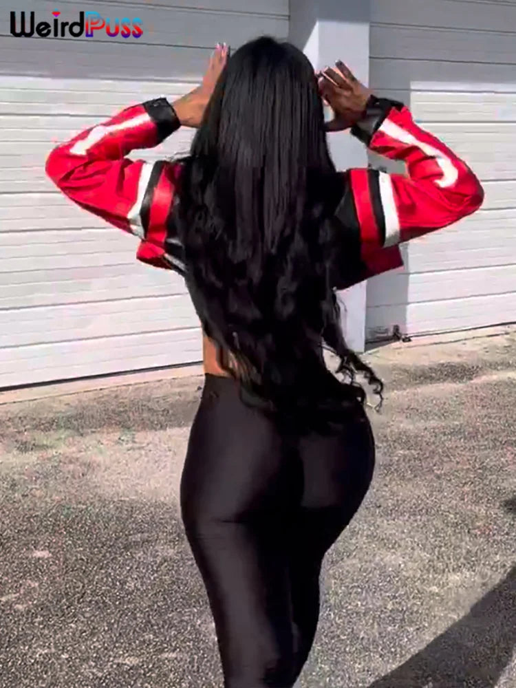 A person with long black hair, wearing a red and black Maramalive™ Faux Leather Women Jacket Hipster Letter Print Autumn Trend Casual Sporty Wild Streetwear Uniform Varsity Crop Coat and black leggings, stands outdoors with their back to the camera, showcasing an Autumn 2023 look.