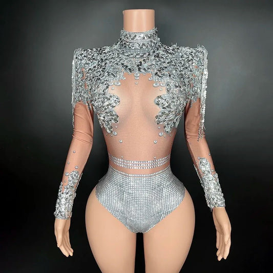 A Maramalive™ mannequin wears a Flashing Silver Sequins Fringe Spandex Bodysuit Women Dancer Singer Performance Costume High-Neck Long Sleeve Nightclub Stage Wear, adorned with intricate silver embellishments and sheer fabric details, set against a plain black background, exuding a sexy club style.