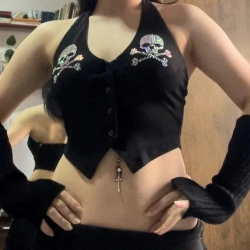 A person wearing the Maramalive™ Goth Dark Skull Rhinestone Mall Gothic Halter Tops Grunge Aesthetic Button Up Emo Crop Top Punk Sexy Backless Bandage Alt Outfit and black fingerless gloves, showing a belly button piercing with a dangling key charm, embodies the E-girl V-neck streetwear aesthetic.