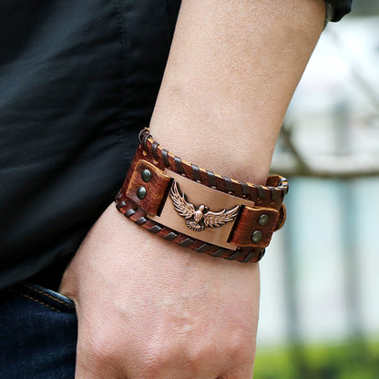 A person wearing a Vintage Weave Nordic Viking Pirate Leather Bracelet with an eagle on it from Maramalive™.
