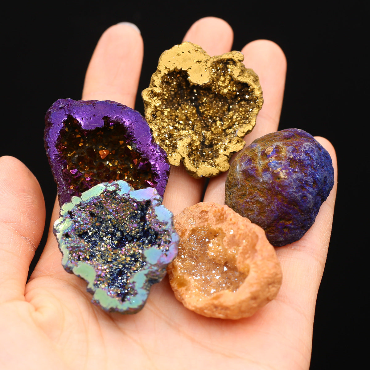 A person holding a hand full of different colored Agate Energy Gem Display Ornaments from Maramalive™.