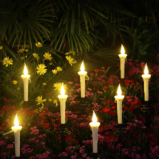 A group of Maramalive™ outdoor solar candle LED ground lamp garden decorations in a garden.