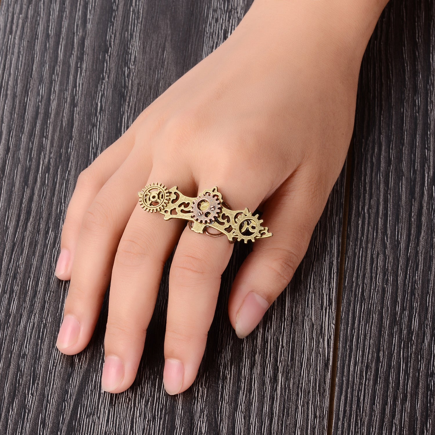 A woman's hand with a Retro Steampunk Bat Gear Ring by Maramalive™ on it.