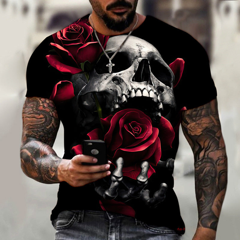 A person with tattoos is wearing a Maramalive™ New Summer Horror Skull 3d Men's T-shirt made of polyester fiber featuring a large 3D digital printing of a skull and red roses. They are holding a mobile phone and have a necklace with a cross pendant.