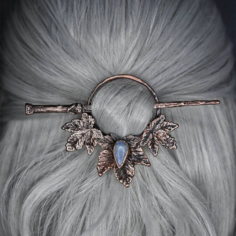 A spooky woman with a Twilight Talon - Gothic Retro Crow Skeleton Moonlight Stone Deer Horn Women's Hairpin by Maramalive™ on her head.