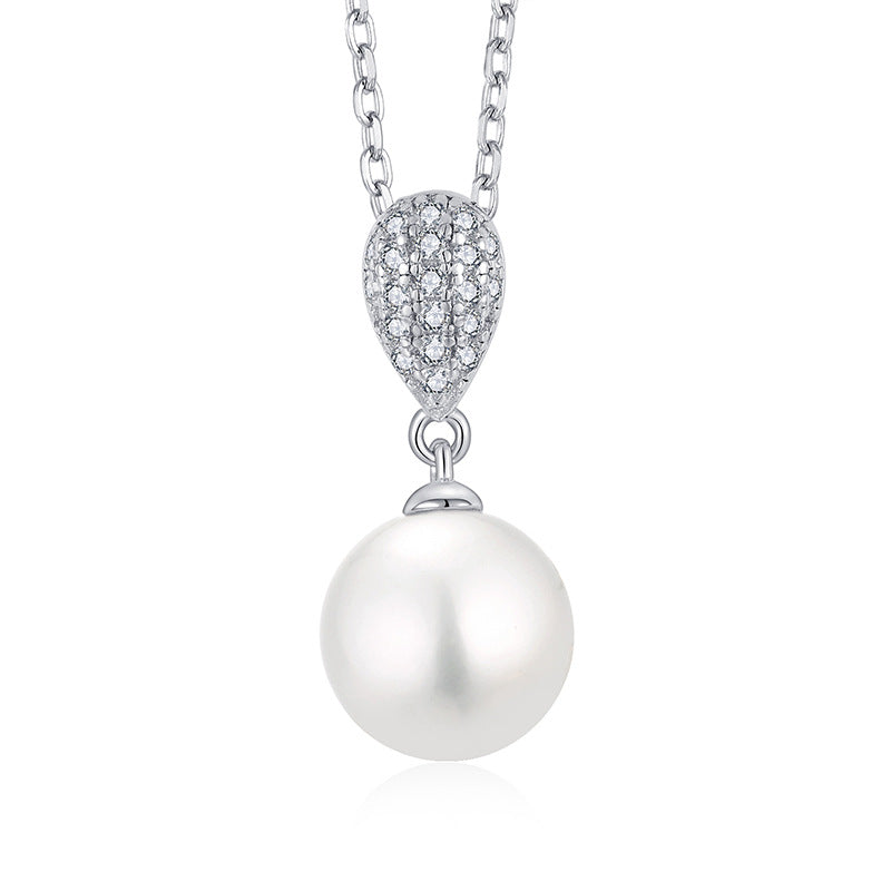 A Maramalive™ I'm Gonna Cry Until I Get One Sterling Silver Zircon Pearl Necklace and earring set on a white table.