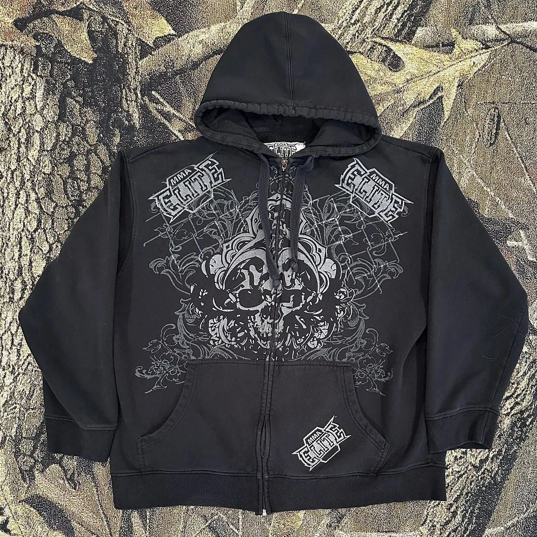 A black Maramalive™ Punk Dark Skull Printed Hoodie Loose Zip Cardigan Sports Pullover Top in hip hop style featuring intricate white and grey design patterns on the front with the words "Elite" printed multiple times. It is displayed against a leafy, camouflage-like background.