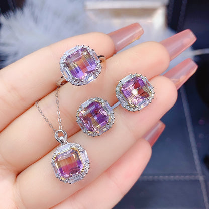 A woman's hand holding the Ascher Amethyst Jewelry Set by Maramalive™.
