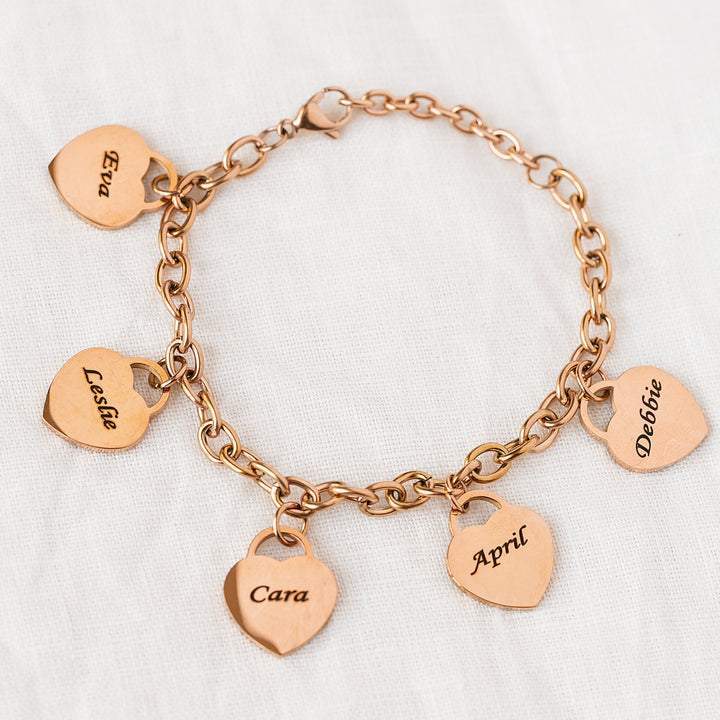 A woman's hand is holding a Love Engraved Bracelet Stainless Steel DIY Personalized from Maramalive™.
