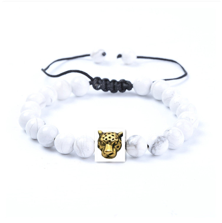 A Black Dragon Agate Lion Head Bracelet by Maramalive™ with a flower on it.