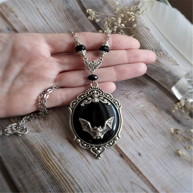 A Halloween Animal Bat Black Gem Necklace with a silver chain by Maramalive™.
