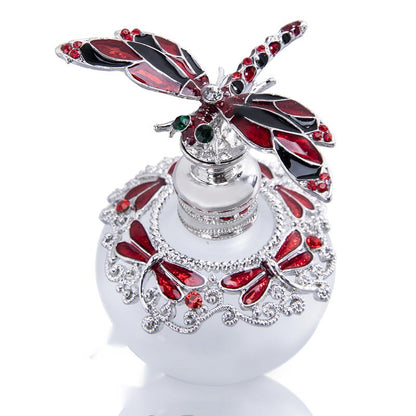 A blue glass Dragonfly Gem Inlaid perfume bottle with a butterfly on it, from the brand Maramalive™.
