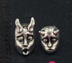 A pair of Gothic Horned Demon Baby Face Stud Earrings Vintage Devil Prajna by Maramalive™ on a white surface.