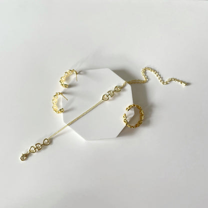 A Minimalist Love Letter Earring set by Maramalive™, plated in gold, on a white surface.