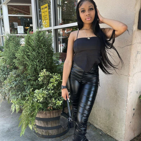 A woman in Sleek Stretch Leather Pants - Pleated High Waist Skinny Ruffled Vegan Jeans by Maramalive™ posing for a picture.